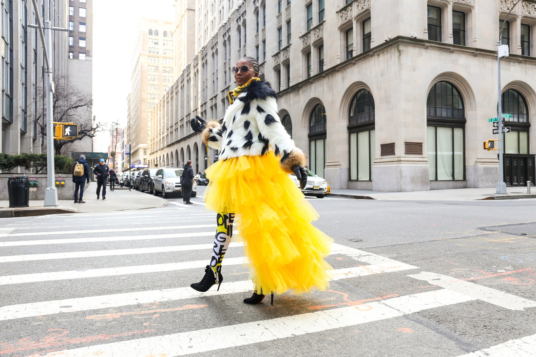 Black and white spotted top with yellow skirt with city background